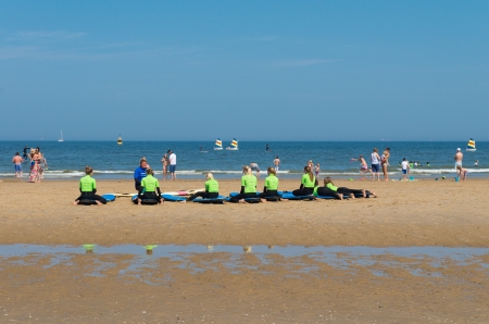 group of children with their teacher following their surfing lessons in Scheveningen, netherlandsのeditorial素材