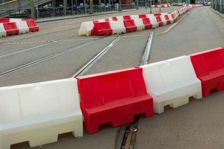 red and white road blocks on a roadの写真素材