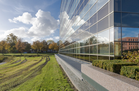 sky reflected in a modern office building glass facadeの写真素材