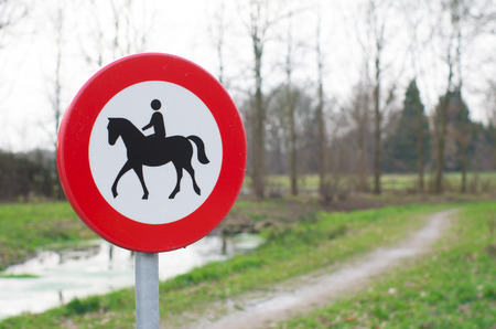 small path with a horseman rider signの写真素材