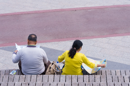 two unknown tourists reading a map in Miniaturk park in istanbul, the largest miniature park in the world. The park contains 105 buildings, each replicated on a scale of 1:25.のeditorial素材