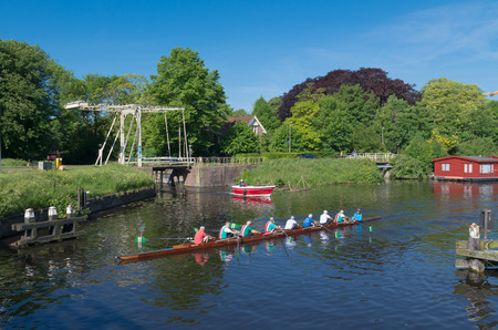 rowers in a canoe in a typical dutch canalのeditorial素材