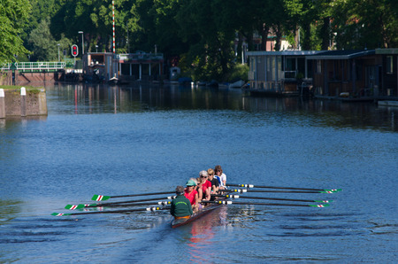female senior rowers in a canoe on a canal in the netherlandsのeditorial素材