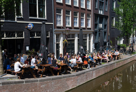 people sitting on a terrace outside an amsterdam cafe. In the city there are over 1500 bars and cafesのeditorial素材