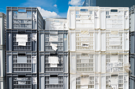 piled up empty plastic crates on an industrial areaの写真素材