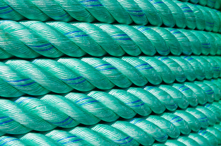 large roll with new green rope for the shipping industry