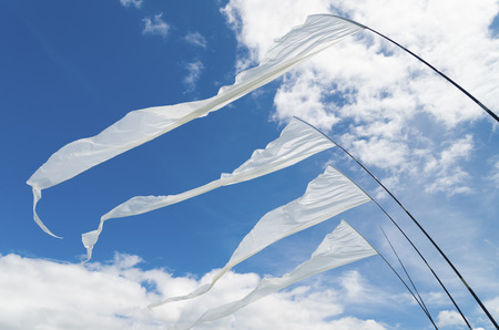 white kite flags waving in the windの写真素材