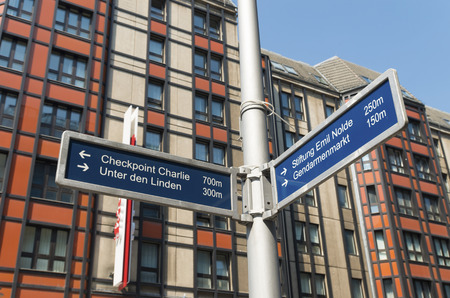 street sign in the famous Friedrichstrasse in Berlin with some wellknown landmarks on itの写真素材