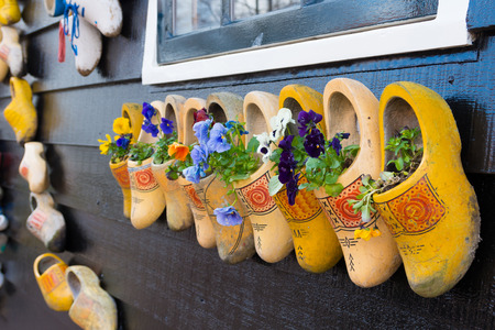 traditional dutch wooden shoes hanging on a wall as decorationの写真素材
