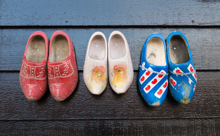 traditional dutch wooden shoes hanging on a wall as decorationの写真素材
