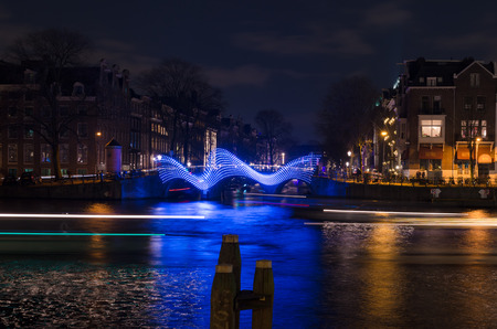 illuminated bridge during the amsterdam light festival. Around december the historical center of Amsterdam presents a unique decor for this free international light and water festivalのeditorial素材