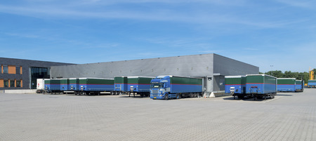 trailers in front of a large warehouse building