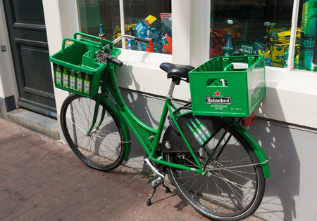 AMSTERDAM - AUGUST 2, 2015: Heineken bicycle in front of the heineken brand store. The Heineken Brand Store is the official store of Heineken with more than 250 unique Heineken products and a Beershopのeditorial素材