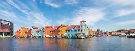 colorful wooden houses in the Groningen Reitdiep harbor in the netherlandsの写真素材