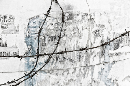 barbed wire with an old wall in the background