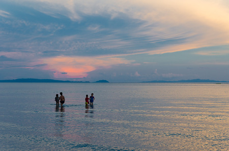 DONSOL, PHILIPPINES - MAY 31, 2015: Unknown local children searching for seafood during a beautiful sunsetのeditorial素材