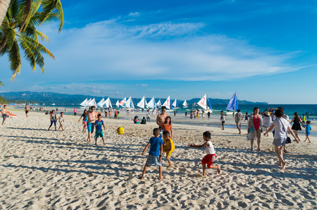 BORACAY, PHILIPPINES - MAY 19, 2015: Unknown local children playing football on the famous boracay white beachのeditorial素材