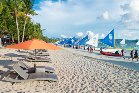 BORACAY, PHILIPPINES - MAY 20, 2015: Tourists on tropical beach. Boracay is one of the main tourist...