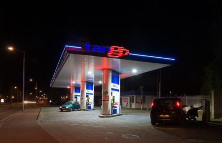 OLDENZAAL, NETHERLANDS - FEBRUARY 28, 2015: Tango gas station at night. Tango CV, a dutch company, introduced and operates unmanned gasoline stations. In 2013 they owned 150 stations.のeditorial素材