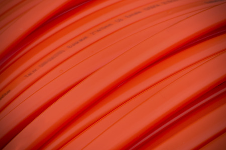 closeup of orange fiber cable on a construction siteの写真素材