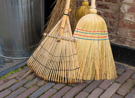 closeup of some brooms for various household cleaning