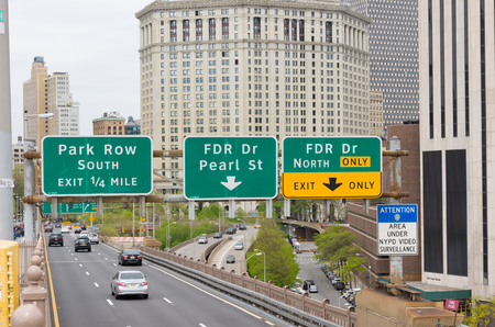 NEW YORK - APRIL 29, 2016: Road signs above brooklyn bridge entering manhattan east sideのeditorial素材
