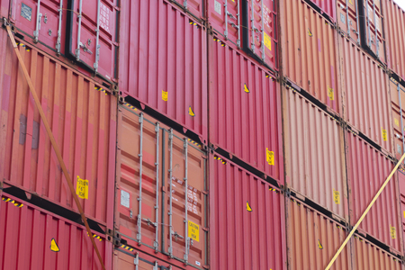 piled up red cargo containers in the rotterdam harbor area