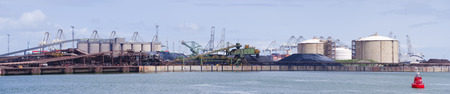 Panoramic shot of a row of silos in the rotterdam bulk terminal, the place for storage and...