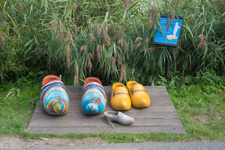 KINDERDIJK, NETHERLANDS - SEPTEMBER 18, 2016: Pair of wooden shoes for tourists to take picturesのeditorial素材