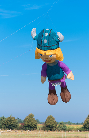 DENEKAMP, NETHERLANDS - SEPTEMBER 25, 2016: Vicke viking kite against a blue sky during a kite festivalのeditorial素材