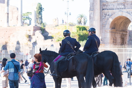 ROME, ITALY - OCTOBER 16, 2016: Two italian police men on horses at the collosseumのeditorial素材
