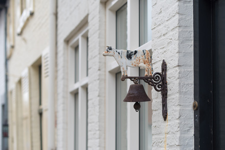 old vintage antique door bell with cow on it
