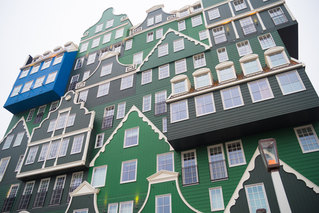 ZAANSTAD, NETHERLANDS - NOVEMBER 13, 2016: Typical facade of the Inntel hotel, opened in 2010. It is an accumulation of almost seventy separate Zaanse houses, executed in four colors Zaans green.のeditorial素材
