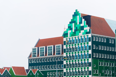 ZAANSTAD, NETHERLANDS - NOVEMBER 13, 2016: Typical facade of the Inntel hotel, opened in 2010. It is an accumulation of almost seventy separate Zaanse houses, executed in four colors Zaans green.のeditorial素材