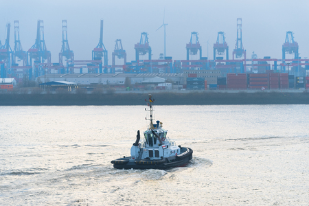 HAMBURG, GERMANY - DECEMBER 20, 2016: pilot boat on the Elbe river with a lot of harbor cranes in the backgrountのeditorial素材
