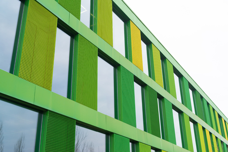 exterior of a green facade of a modern office buildingの写真素材