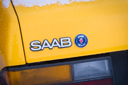 OLDENZAAL, NETHERLANDS - JANUARY 15, 2017: Detail of a yellow vintage Saab 900 turbo S convertible in snowy conditions.のeditorial素材