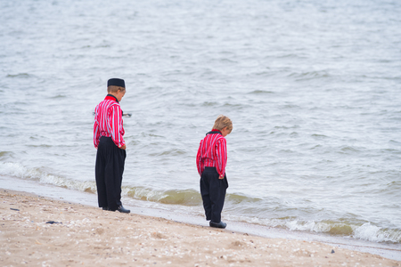 URK, NETHERLANDS - MAY 19, 2018: Unknown boys in traditional costumes on the Urkerdays. Urk is on of the best-known fishing villages in the country with the largest fishing fleet.のeditorial素材