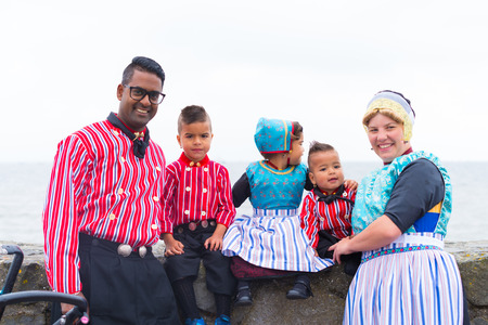 URK, NETHERLANDS - MAY 19, 2018: Unknown family in traditional costumes on the Urkerdays. Urk is on of the best-known fishing villages in the country with the largest fishing fleet.のeditorial素材