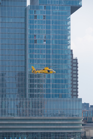 ROTTERDAM, NETHERLANDS - SEPTEMBER 3, 2017: Yellow offshore rescue helicopter doing a demonstration during the Rotterdam world port daysのeditorial素材