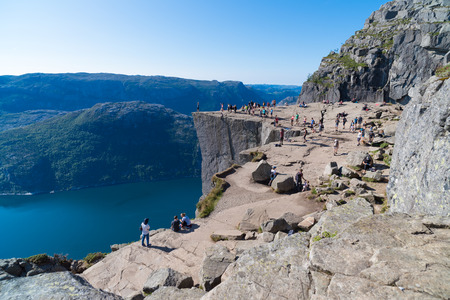 PULPIT ROCK, NORWAY - JULY 26, 2018: Unknown tourists enjoying the stunning view on Pulpit Rock. The Pulpit Rock or Preacherâs Chair is a tourist attraction in the municipality of Forsand in Rogaland countyのeditorial素材