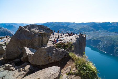 PULPIT ROCK, NORWAY - JULY 26, 2018: Unknown tourists enjoying the stunning view on Pulpit Rock. The Pulpit Rock or Preacherâs Chair is a tourist attraction in the municipality of Forsand in Rogaland countyのeditorial素材
