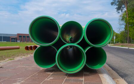 stack of large green pvc pipes for a sewerの写真素材