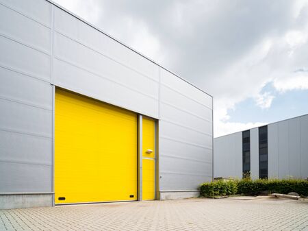 commercial warehouse exterior with a yellow roller door
