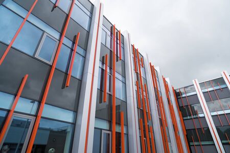 exterior of a modern office building with some orange accentsの写真素材