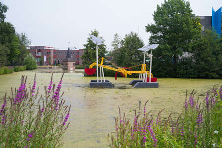 ENSCHEDE, NETHERLANDS - JUNE 16, 2018: The Taaie Tiller is a moving sculpture (kinetic work of art) on wind power and hydropower - persistent who knows nothing about it - drama and euphoria - building tension and splashing sensation - the center of all atのeditorial素材