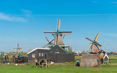 ZAANSE SCHANS, NETHERLANDS - OCTOBER 13, 2018: Traditional windmill in the Zaanse Schans, a neighborhood with historic wooden buildings in the municipality of Zaanstad.のeditorial素材