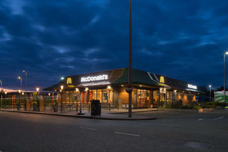 OLDENZAAL, NETHERLANDS - SEPTEMBER 25, 2019: Exterior of an McDonalds fast food restaurant at sunset.のeditorial素材