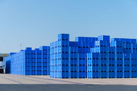 piled up empty blue crates