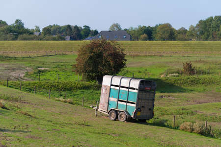 old horse trailer in a meadowのeditorial素材